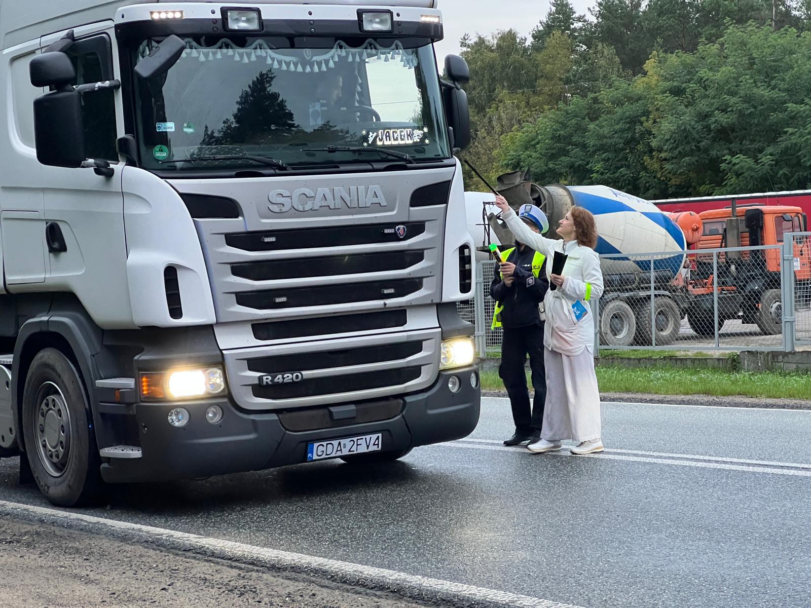KOBIETA Z KOBIETĄ W MUNDURZE SPRAWDZAJĄ TRZEŻWOŚĆ I WRĘCZAJĄ ULOTKI